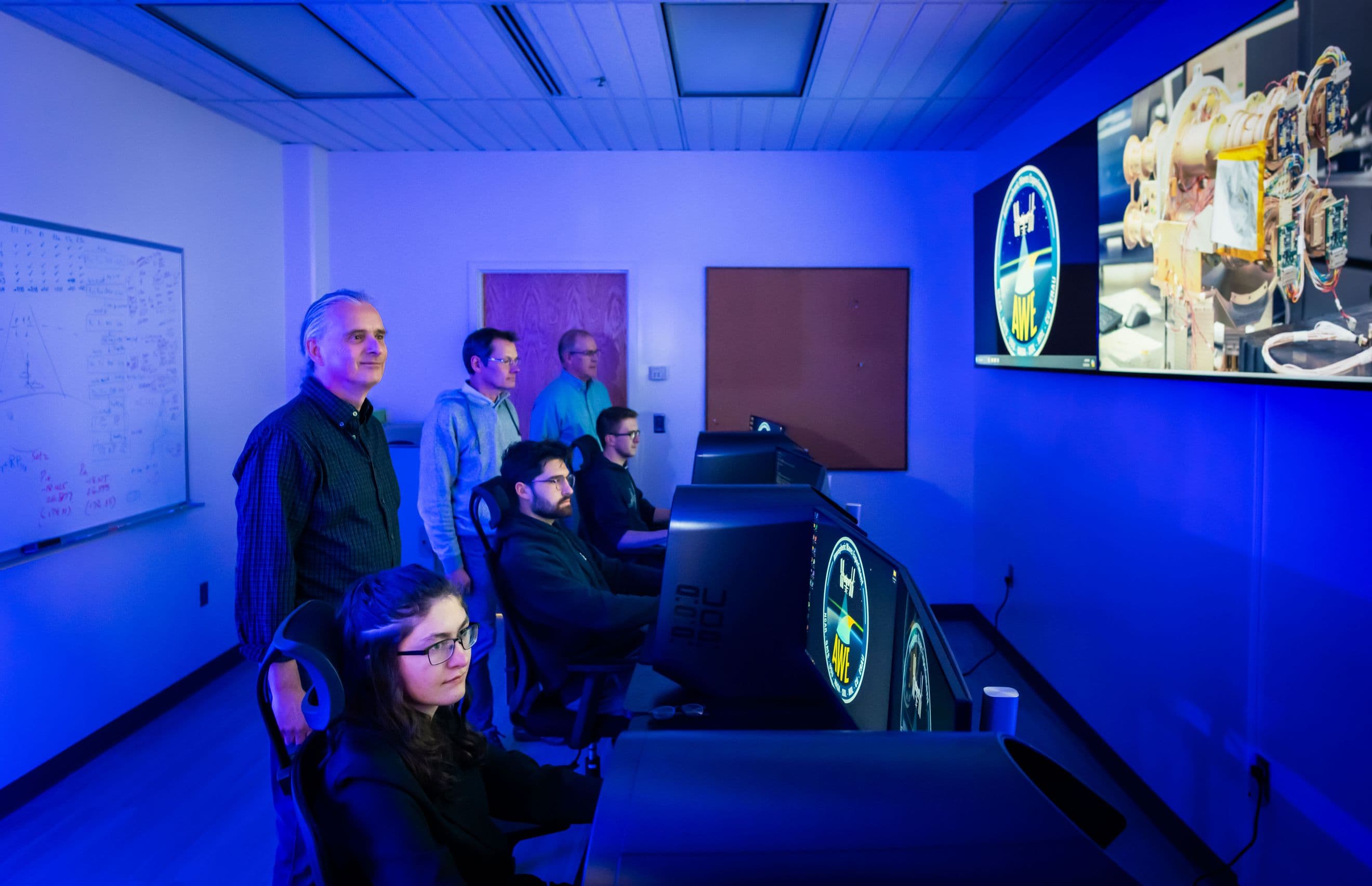 An image of scientists and programmers at their computers