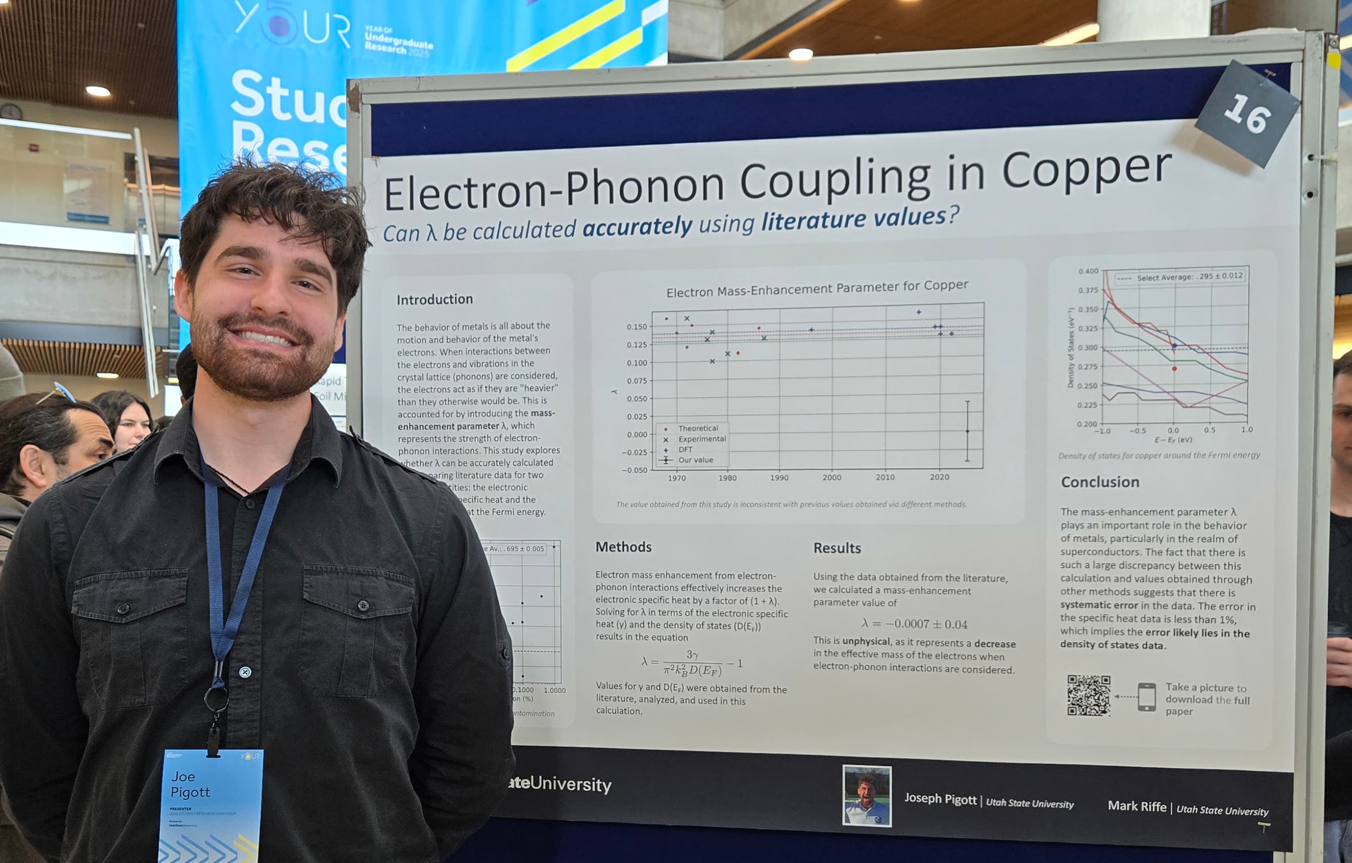 A photo of me standing in front of my poster presentation at the 2025 USU Spring Research Symposium